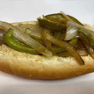 a hot dog with onions and peppers