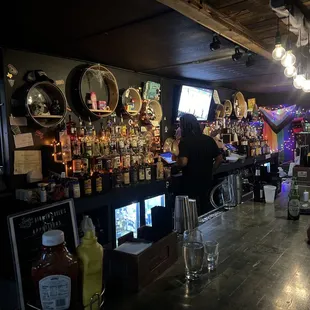 a bar with lots of bottles of alcohol
