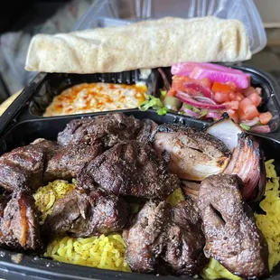 a tray of meat and rice