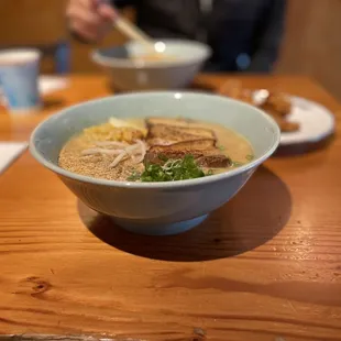 a bowl of soup on a wooden table