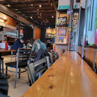 people sitting at tables in a restaurant