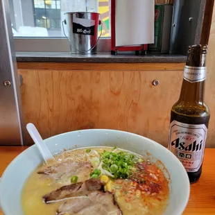 a bowl of soup and a bottle of beer