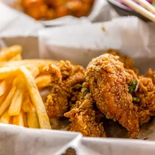 a basket of fried chicken and french fries