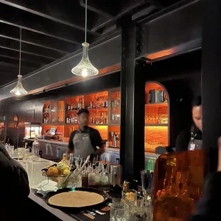 a man behind a bar at a restaurant