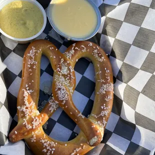 a pretzel with mustard and dip