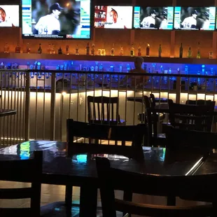 a bar with multiple televisions