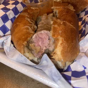 a half eaten sandwich in a basket