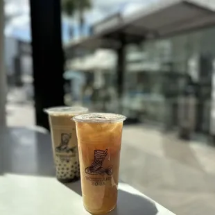 two cups of boba on a table
