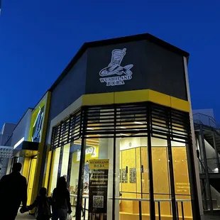 people walking in front of a store