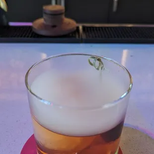 a drink in a glass on a table