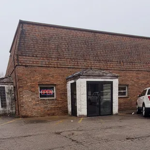 a car parked in front of a brick building