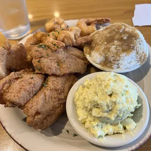 Fried fish, fried shrimp, potato salad, rice and gravy