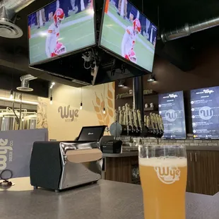 a glass of beer on a bar