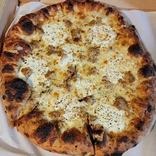 Cape Blanco pizza (olive oil, ricotta, mozzarella, pecorino, herbs, fresh garlic, cracked pepper, and sausage)