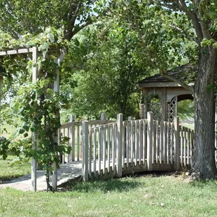a wooden gazebo surrounded by trees