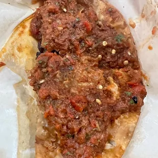 a piece of pizza in a wrapper