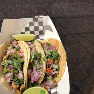 two tacoss in a basket