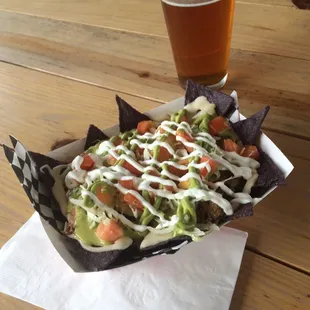 Borracho nachos! Local brew based queso blanco on organic blue corn chips!