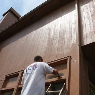 Exterior residential painting by a Wyman crew member. Omaha.