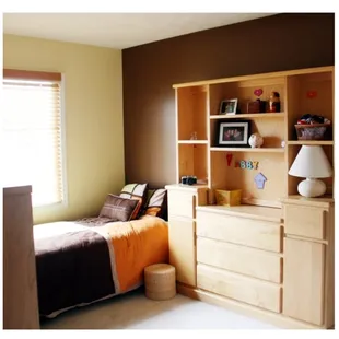 a bedroom with a bed and a dresser