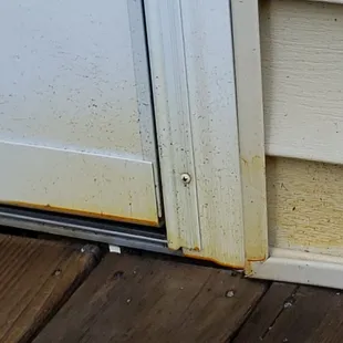 Over spray on storm  Door and  Siding  by Chris Wyman