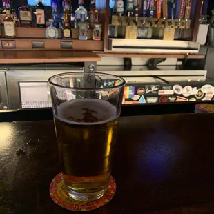 a pint of beer on a bar