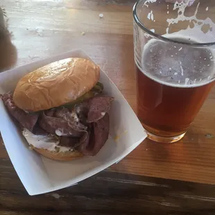 a sandwich and a glass of beer
