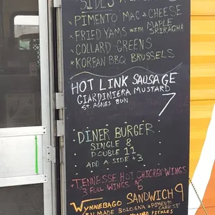 a menu on the side of a food truck