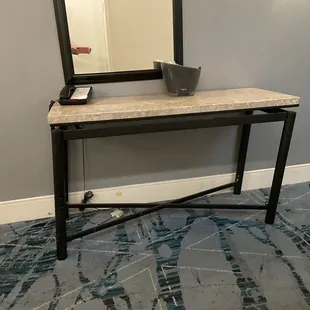 Broken table in hallway off elevator