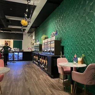 pink chairs and a green wall