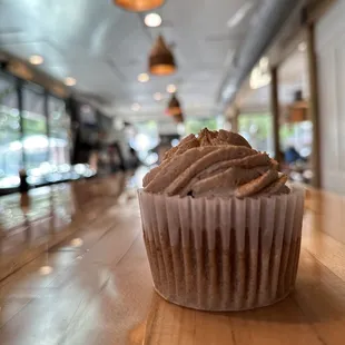 a cupcake on a wooden table
