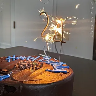 a chocolate birthday cake with sparklers