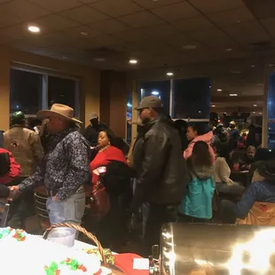 a crowd of people standing around a table