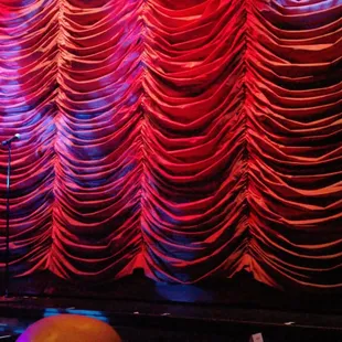 a stage with a red curtain