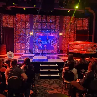 a stage with people sitting in chairs