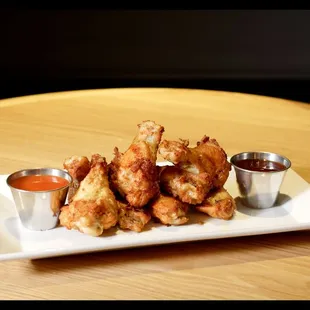 a plate of chicken wings with dipping sauce