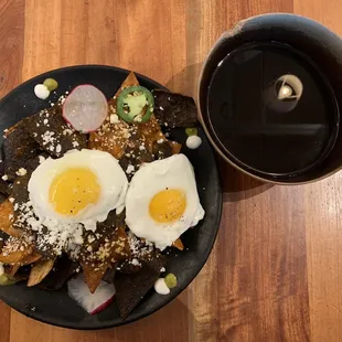 Enchiladas Rojas with two side eggs to top them, and café de olla.