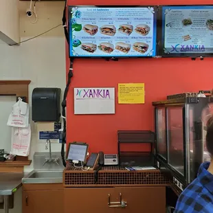 a man sitting at a counter in a restaurant