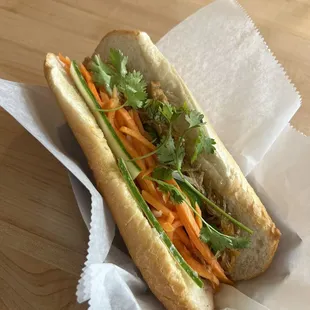 a hot dog with carrots and cilantro