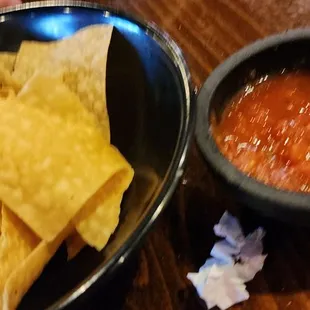 a bowl of chips and a bowl of salsa