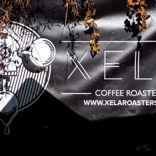 a sign for xela coffee roasters