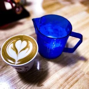 a blue pitcher and a cup of coffee