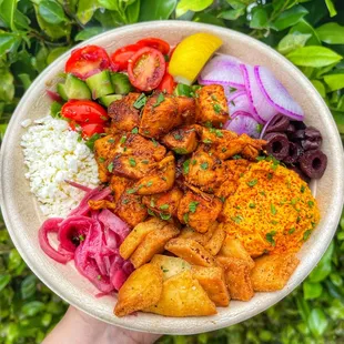 a person holding a bowl of food