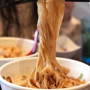 Hand-stretched noodles in hot &amp; sour sauce +pork elbow 油波面加蹄膀 ($12) - not very spicy. Noticeable vinegar flavor.