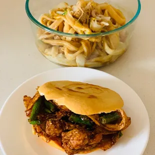 a plate of food and a bowl of noodles