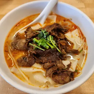 a bowl of beef and noodles