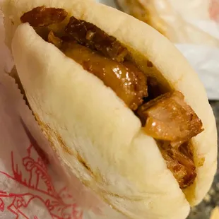 a hot dog with meat in a bun