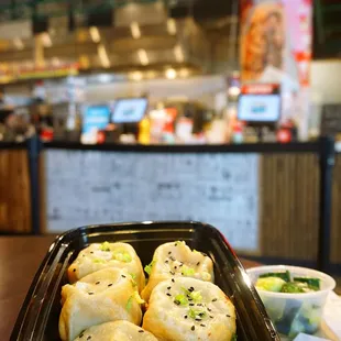 Sheng Jian Bao (生煎包): five count of classic, juicy pork filling. Comes with side of garlic cucumber or Sichuan cabbage ($13).