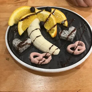 a banana, pretzel, and pretzel on a plate