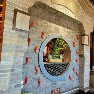 a circular mirror in the center of a fountain